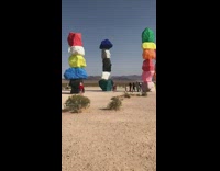 Woman pink violet shorts savanna colored rocks