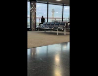 Woman poses at airport near a man