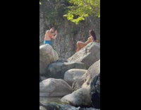 Girl bikini lay on boulder creek stream