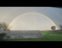 Double rainbow on the sky green house