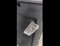 Paper returns and sticks to garbage bin