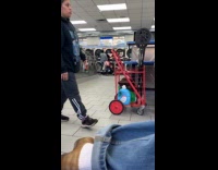 Woman at laundromat with pet bird on shoulder