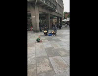 Kid tries to take donation jar from performers