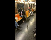 Pink shirt gas mask guy rides subway 