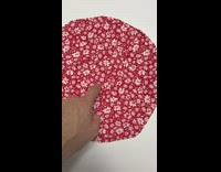 Red circular floral cloth moved by a finger