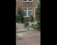 Woman black dress coat music video shoot sidewalk