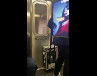 [third party - video] Man ride train carry advertisement screen backpack