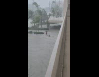 Guy chills and floats in flood on inflatable