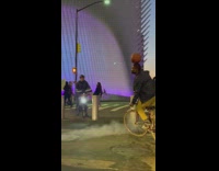 Guy rides bicycle in circle basketball head