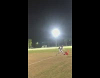 Footballer catches ball before rolling 