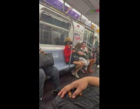 Person holding sword with pink handle on subway