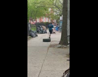 Man Drags Tire on Sidewalk 