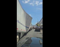 Filmer pass beside truck with crushed container