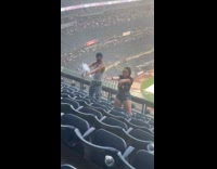 Man and woman dance during rain delay