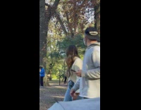 Red sweater guy swings around metal bar 