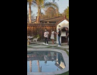 Four people tiktok dance by the pool at the backyard