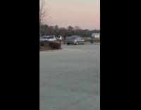 Woman black cowboy outfit parking lot photoshoot