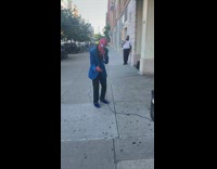 Spiderman sings on sidewalk 