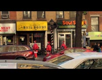 Four people inflatable Santa costume on sidewalk