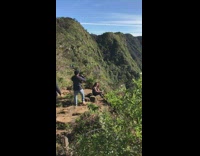 Woman takes picture on tall mountain