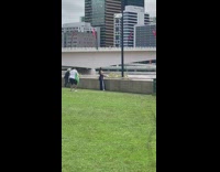 Woman in blue dress poses near the flood