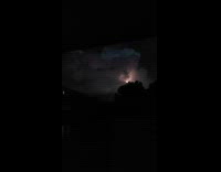 Woman films a silent lightning inside a cloud