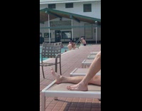 Woman pink bikini bend over poolside photoshoot