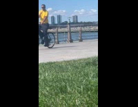 Collab WINY - Man yellow shirt on bike playing flute 