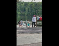 Woman in cyan dress poses on the lake shore Part 2