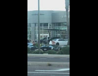 Shirtless guy dance outside car display shop