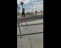 girl oink hat holding skateboard park