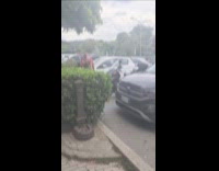 Man smokes vape while he carries dog