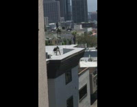 Guy on roof stands on ledge jumps on roof