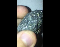 Shiny rock with sparkles shown by the filmer