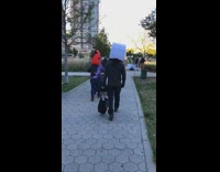 Person large white costume mask black bag