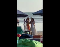Three women bikini dress dances at beach