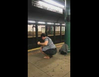 barefoot man does yoga on subway platform