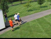 Collab dogIG_default - White Dog Excitedly Greets Maintenance Team on Lawn