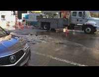 Street cracks open and floods with brown muddy water