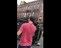 Overturned car on street wheelchair falls over