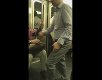 man in white shirt black pants wiggle dance on subway train