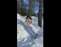 Girl throws handful of snow 