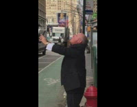 Guy holds out phone to record and screams  on the street