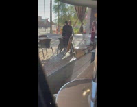 Two women tiktok dance near woman reporter