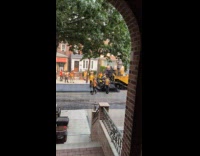 Construction men putting asphalt on street blasting music 