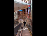 Guy on escalator shows empty hotel lobby 