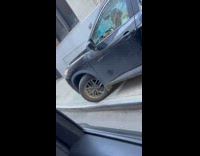 Garbage truck blocks road car drives sidewalk