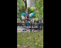 Guy wearing spiderman costume dances with scarves 