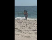 Girl bikini hold hands beach blue shorts