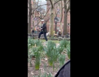 Man suit and hat exercises at park